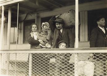 LEWIS W. HINE (1874-1940) Italian family on the ferry boat landing at Ellis Island.